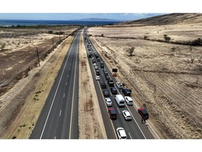 WAILUKU, HAWAII - AUGUST 11: In an aerial view, cars back up for miles on the Honoapiilani highway as residents are allowed back into areas affected by the recent wildfire on August 11, 2023 in Wailuku, Hawaii. Dozens of people were killed and thousands were displaced after a wind-driven wildfire devastated the town of Lahaina on Tuesday. Crews are continuing to search for missing people.