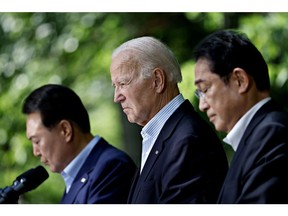 Yoon Suk Yeol, South Korea's president, from left, US President Joe Biden and Fumio Kishida, Japan's prime minister, at a news conference during a trilateral summit at Camp David, Maryland, US, on Friday, Aug. 18, 2023. Biden is looking for a way to weave the US trilateral relationship with allies Japan and South Korea so tightly together it wont unravel as it has done in the past.
