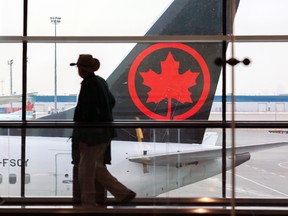 A traveller passes an Air Canada plane at Calgary's international airport.