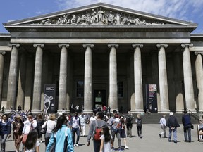 FILE - Visitors walk outside the British Museum in Bloomsbury, London, Friday, June 26, 2015. The British Museum said a member of staff has been dismissed after items were found to be missing, stolen or damaged. The museum said Wednesday, Aug. 16, 2023 it has also ordered an independent review or security and ordered kickstart a ''vigorous program to recover the missing items.''
