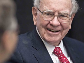 Warren Buffett, chairman and chief executive officer of Berkshire Hathaway Inc., laughs while playing cards on the sidelines the Berkshire Hathaway annual shareholders meeting in Omaha, Nebraska, U.S., on Sunday, May 1, 2016. Dozens of Berkshire Hathaway subsidiaries will be showing off their products as Chief Executive Officer Warren Buffett hosts the company's annual meeting. Photographer: Bloomberg/Bloomberg