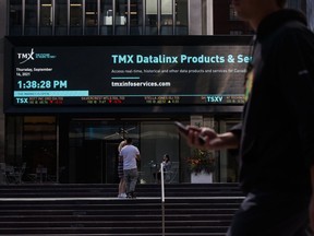 Pedestrians pass in front of the Toronto Stock Exchange in the financial district of Toronto.