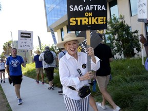 Actor Holland Taylor walks on a picket line outside Netflix studios on Wednesday, July 26, 2023, in Los Angeles. The actors strike comes more than two months after screenwriters began striking in their bid to get better pay and working conditions.