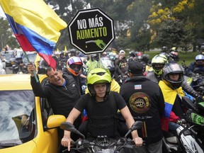 Motorcycle riders hold a caravan to protest the increase in gas prices in Bogota, Colombia, Monday, Aug. 28, 2023.
