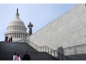 People walk down steps in front of the U.S. Capitol building in Washington, D.C., U.S.