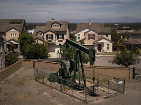 FILE - A pump jack extracts oil at a drilling site next to homes June 9, 2021, in Signal Hill, Calif. Environmental advocates in California will try to enshrine a law banning new gas and oil wells near homes, schools and hospitals in a move that comes as the oil industry is vying for voters to overturn it.