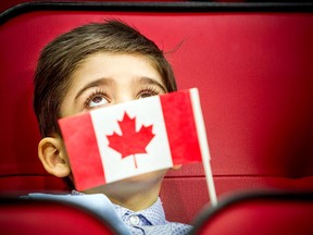 A new young Canadian attends a citizenship ceremony in Ottawa.