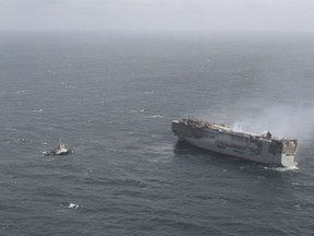 The freight ship, the Fremantle Highway, in the North Sea, Sunday July 30, 2023. Salvage crews began towing a burning cargo ship loaded with thousands of new cars to a temporary anchorage off the northern Dutch coast on Sunday after smoke from the stricken vessel eased, authorities said. (Kustwacht Nederland/Coast Guard Netherlands via AP)