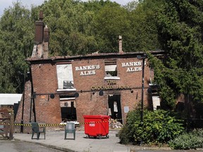 FILE - The burnt remains of The Crooked House pub in Himley. England, Aug. 7, 2023. British police said Thursday Aug. 24, 2023, two men have been arrested on suspicion of burning down an historic English pub that was famous for its lopsided walls and sagging foundation.