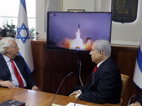 FILE - Israeli Prime Minister Benjamin Netanyahu, right, and US Ambassador to Israel David Friedman watch a video which shows the launch of the Arrow 3 hypersonic anti-ballistic missile during a cabinet meeting in Jerusalem on July 28 2019. The United States cleared a weapons agreement between Israel and Germany that marks Israel's largest-ever defense deal on Thursday Aug. 17, 2023.