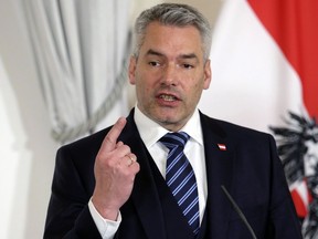 FILE - Austrian Chancellor Karl Nehammer briefs the media during a meeting with Netherlands Prime Minister Mark Rutte in Vienna, Austria, on Jan. 26, 2023. Austria's leader is proposing to enshrine in the country's constitution a right to use cash, which remains more popular in the Alpine nation than in many other places. Nehammer said in a statement on Friday Aug. 4, 2023 that "more and more people are concerned that cash could be restricted as a means of payment in Austria."