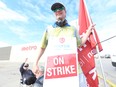 Striking Metro grocery store workers of Unifor Local 414 man picket lines in Toronto's east side.