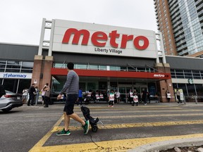 Workers are seen on strike on a picket line outside a Metro grocery store in Toronto on Saturday, July 29, 2023. Metro Inc. says it's asked a conciliation officer to step in and help it find a resolution with workers at the bargaining table.