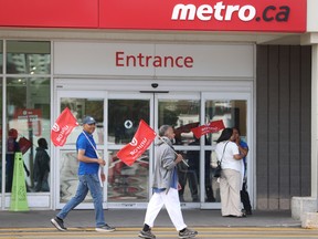 Striking Metro grocery store workers at a Toronto store on Aug. 1.