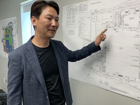 NextStar Energy chief executive Danies Lee shows blueprints of the Windsor battery plant in July. By the time hiring is complete in 2025, the plant will have 2,500 employees.