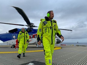 Magnus Haakon, right, and Jonas Gahr Store during a visit to the Hywind Tampen wind park in North Sea, Norway, on Aug. 23.