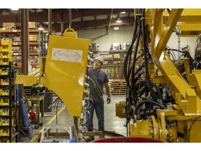 Kyle Kersbergen works on heavy machinery at Weiler, a manufacturing factory, in Knoxville, Iowa, US, on Thursday, July 21, 2023. Photographer: Rachel Mummey/Bloomberg