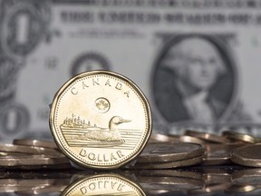The Canadian dollar coin displayed next to the U.S. dollar.