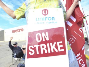 Striking Metro Inc. grocery store workers of Unifor Local 414 hold picket lines in Toronto.