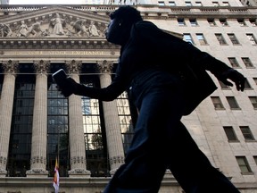 A person walks near the New York Stock Exchange.