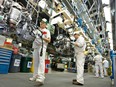 Employees working on the production line of cast aluminium engines at Honda Motor Co. Ltd.'s engine plant in Alliston, Ont.