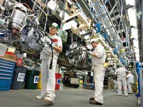 Employees working on the production line of cast aluminium engines at Honda Motor Co. Ltd.'s engine plant in Alliston, Ont.