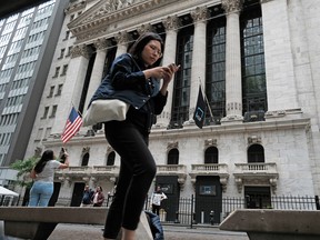 People walk by the New York Stock Exchange.