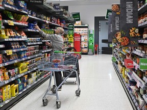 A customer looks at some goods at the Asda supermarket in Aylesbury, England.