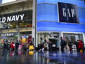 Pedestrians walk past Old Navy and Gap stores in Times Square in New York City.