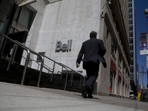 A pedestrian walking past a Bell Canada office in Toronto.