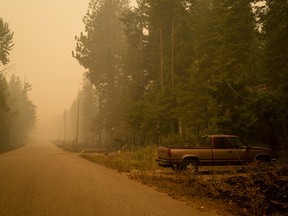 Downed power lines on a pickup truck in an area burned by the Lower East Adams Lake wildfire in Scotch Creek, B.C.