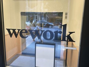 FILE - A sign for WeWork is displayed at the workspace-sharing office in the borough of Manhattan in New York, Aug. 9, 2023. WeWork said on Tuesday, Aug. 8, that there was "substantial doubt" on its ability to stay in business, prompting speculation around the future of the troubled workspace-sharing company.