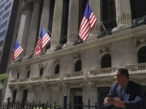 FILE - A trader stands outside the New York Stock Exchange, Friday, Sept. 23, 2022, in New York.