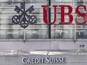 FILE - The logos of the Swiss banks Credit Suisse and UBS are pictured in Zurich, Switzerland, June 12, 2023. In an announcement made on Monday, Aug. 14, 2023, UBS will pay U.S. authorities $1.44 billion to settle the last lingering legal case over Wall Street's role in the housing bubble of the early 2000s, which ultimately led to the 2008 financial crisis and Great Recession.