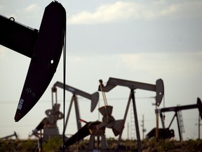 FILE - Pump jacks work in a field near Lovington, N.M., April 24, 2015. Record-breaking oil production in New Mexico is likely to provide state government with a new multibillion-dollar surplus during the upcoming budget year, economists for the state announced Wednesday, Aug. 23, 2023.