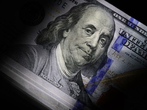 File - The likeness of Benjamin Franklin is seen on U.S. $100 bills, Thursday, July 14, 2022, in Marple Township, Pa. With the help of technology, scammers are tricking Americans out of more money than ever before. But there are steps you can take to keep your money and information safe.
