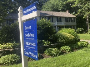 A sign noting a pending sale is shown in front of a home on Sunday, Aug. 20, 2023, in Concord, Mass. On Tuesday, Aug. 22, 2023, the National Association of Realtors reports on sales of existing homes in July.
