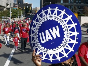FILE - United Auto Workers members walk in the Labor Day parade in Detroit, Sept. 2, 2019. The United Auto Workers union says it has filed unfair labor practice complaints against Stellantis and General Motors for failing to make counteroffers to the union's economic demands. Ford was the only company of the Detroit Three automakers to make such an offer, but it rejected most of the union's proposals, President Shawn Fain told workers Thursday, Aug. 31, 2023, in a Facebook Live meeting.