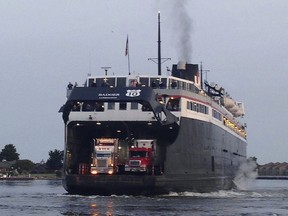 FILE - The SS Badger docks in Ludington, Mich., to unload passengers and vehicles that made a 4-hour trip from Manitowoc, Wis., Friday, July 3, 2015. The operators of the historic ferry that carries traffic across Lake Michigan between Michigan and Wisconsin said Tuesday, Aug. 1, 2023, it is out of service for the rest of the season after its ramp system was damaged in July.