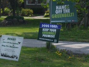 Signboards expressing opposition to Ontario's plans for the Greenbelt are seen outside homes within the Duffins Rouge Agricultural Preserve.
