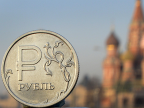 Ruble against backdrop of St. Basil's in Moscow