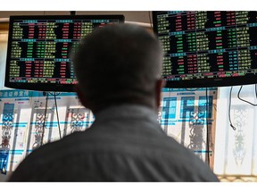 An investor monitors stock price  Photographer: Hector Retamal/AFP/Getty Images