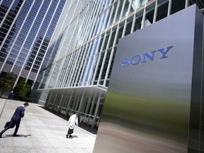 FILE - People walk past the headquarters of Sony Corp. in Tokyo, on May 10, 2022. Sony's April-June profit slipped 17% from a year earlier, as worries grew about revenue damage from a strike in the movies sector, the Japanese electronics and entertainment company said Wednesday, Aug. 9, 2023.