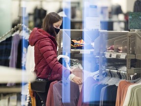 Statistics Canada will release its latest reading for inflation on Tuesday when it publishes its consumer price index for July. A woman shops in a clothing store in Montreal, Sunday, November 22, 2020.THE CANADIAN PRESS/Graham Hughes