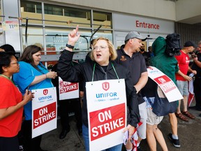 Lana Payne, Unifor national president, shouts alongside workers at a picket line outside a Metro grocery store in Toronto.