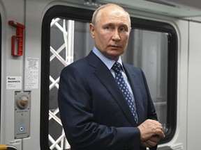 Russian President Vladimir Putin stands in a railway carriage exploring the Manezh Metro Station exhibition prior to the ceremony to launch passenger traffic on the Line D3 of Moscow Central Diameters via videoconference, at the Manezh Central Exhibition Hall in Moscow, Russia, Thursday, Aug. 17, 2023. The 85-kilometer-long (53 miles) D3 will link Zelenograd and Ramenskoye.