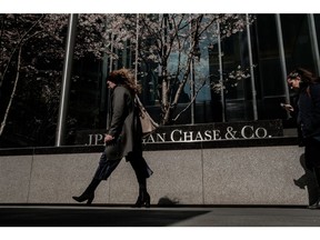 Pedestrians pass in front of a JPMorgan Chase & Co. office building in New York, U.S., on Wednesday, April 11, 2018. JPMorgan Chase & Co. is scheduled to release earnings figures on April 13. Photographer: Christopher Lee/Bloomberg