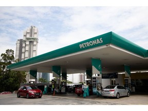 Vehicles are refueled at a Petroliam Nasional Bhd. (Petronas) gas station in Johor Bahru, Johor, Malaysia, on Thursday, June 20, 2019. Malaysia's Prime Minister Mahathir Mohamad said he underestimated the challenges of governing the country before his shock election victory last year. "I underestimated because we were on the outside and we didn't get any information on what was happening on the inside," Mahathir said.