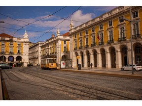 A tram passes through Praca do Comercio in Lisbon, Portugal on Thursday, May 14, 2020. The European Union's executive arm pushed for a continent-wide revival of tourism with a series of policy recommendations for EU countries as they loosen lockdowns triggered by the coronavirus pandemic. Photographer: Jose Sarmento Matos/Bloomberg