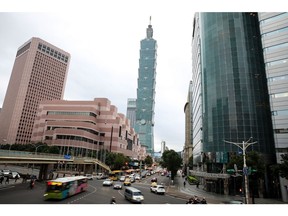 Vehicles travel along a road in front of the Taipei 101 building, center, in Taipei, Taiwan, on Wednesday, Nov. 24, 2021. Taiwan, home to several major producers of leading-edge semiconductors, has been among the biggest beneficiaries of a global rebound in trade as the Covid-19 pandemic eases.